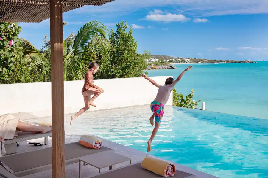 Family enjoying the pool at La Mer South Luxury Villa Rental on Sapodilla Bay